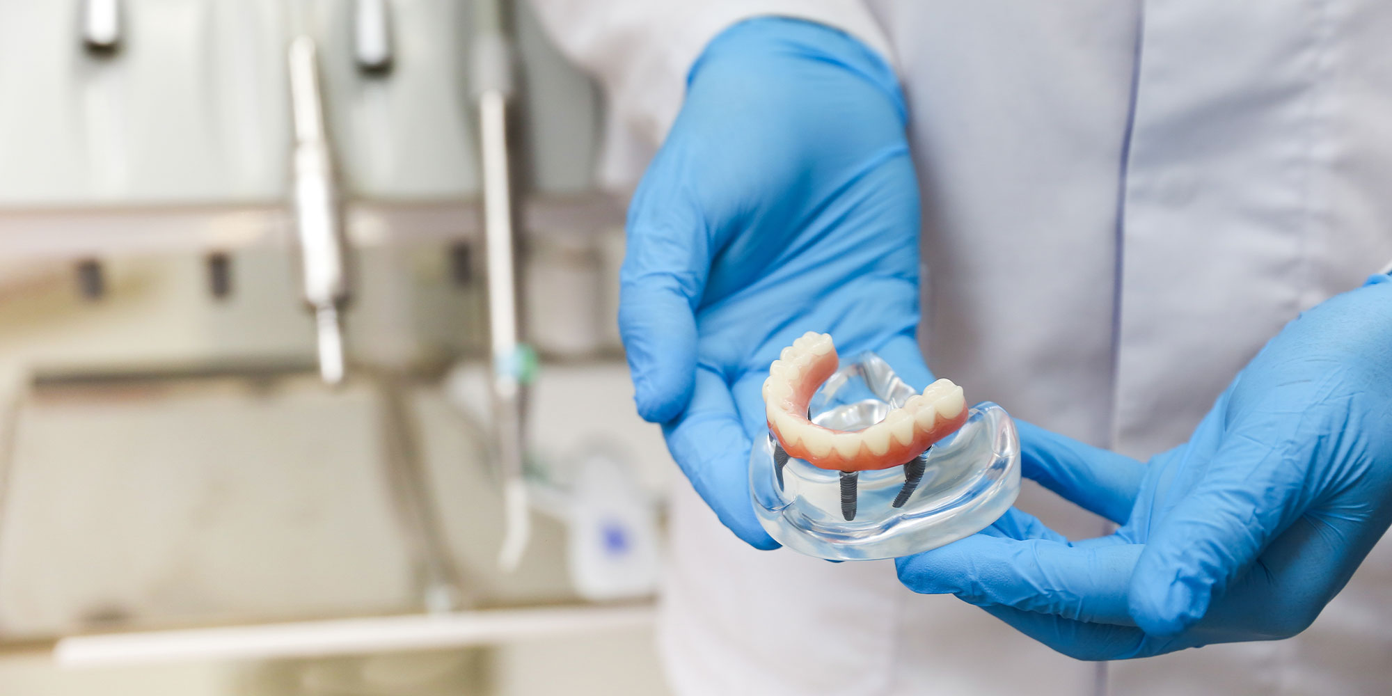 dentist holding dental implants